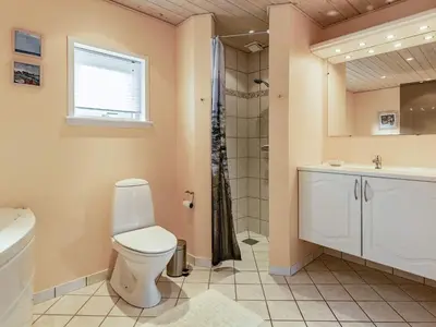 a bathroom with a toilet and a shower and a sink at 8 person holiday home in Spøttrup in Spottrup