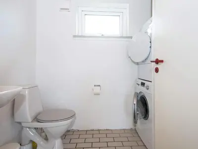 a white bathroom with a toilet and a window at 10 person holiday home in Harboøre-By Traum in Harboør