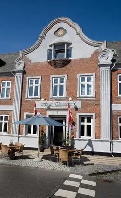 a building with tables and chairs in front of it at Hotel Thinggaard in Hurup