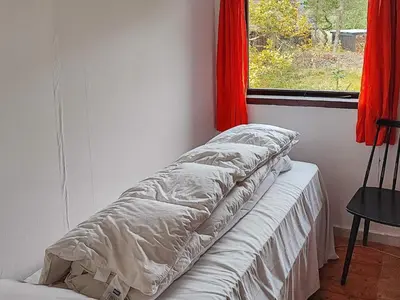 a bed sitting in a room with a window at 6 person holiday home in Thisted-By Traum in Torsted