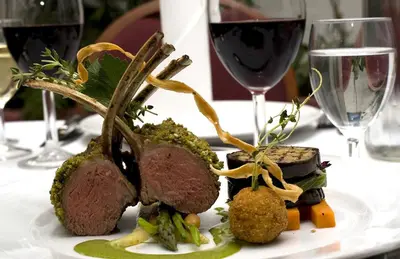 a plate of food on a table with wine glasses at Rold StorKro in Skorping