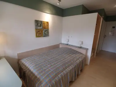 a bedroom with a bed with a striped blanket at Rold StorKro in Skorping