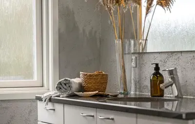 a kitchen counter with a bottle of wine and a vase at Three-Bedroom Holiday Home In Vestervig in Vestervig