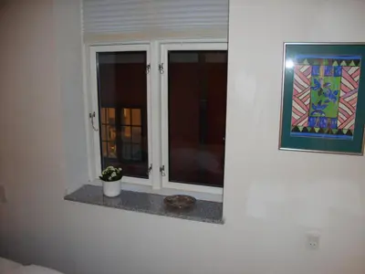 a window in a room with a plant on a counter at Klosterpensionen in Viborg