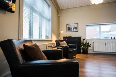 a living room with two chairs and a couch at Bed & Breakfast Holstebro in Holstebro