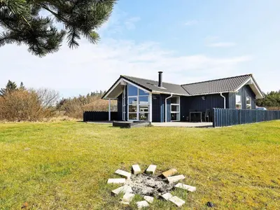 a house on a grassy field with a tree at Luxury Retreat in Vorupor - By Traum Ferienwohnungen in Nørre Vorupør