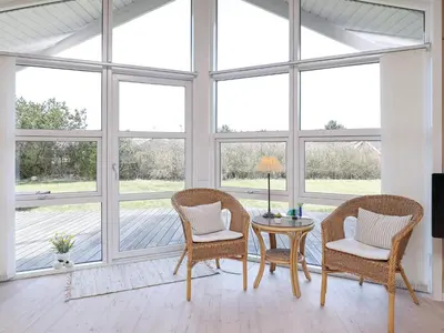 a room with a table and chairs and windows at Luxury Retreat in Vorupor - By Traum Ferienwohnungen in Nørre Vorupør