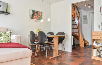 a living room with a table and chairs at 2 Bedroom Lovely Apartment In Lemvig in Lemvig