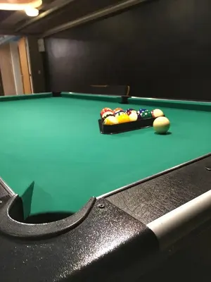 a green pool table with a cue ball on it at Idrætscenter Jammerbugt in Fjerritslev