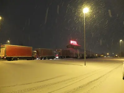 a group of trucks parked in a parking lot in the snow at Motel Spar 10 in Viborg