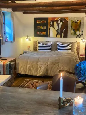 a bedroom with a bed and a candle on a table at Holmsminde in Viborg