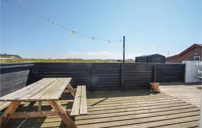 a wooden picnic table on the roof of a building at Three-Bedroom Holiday Home In Frostrup in Frøstrup