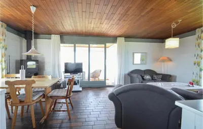 a living room with a table and chairs and a bedroom at Three-Bedroom Holiday Home In Frostrup in Frøstrup