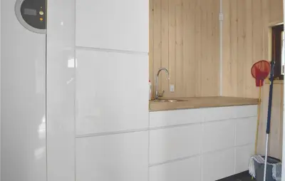 a kitchen with a sink and a counter top at Five-Bedroom Holiday Home In Lokken in Løkken