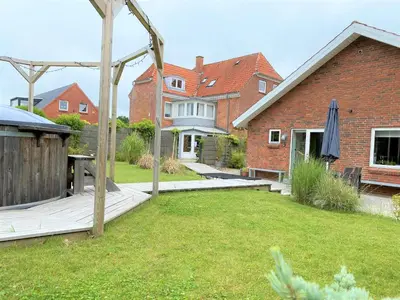 a house with a yard with a wooden deck at Apartment med udsigt over Nordmors in Sejerslev