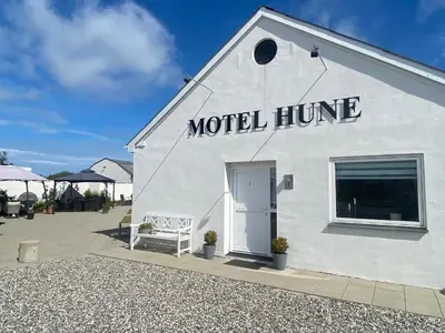 a white building with the words motel home on it at Motel Hune Apartments in Blokhus