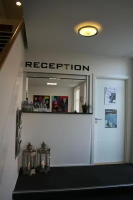 a reception sign above a door in a building at Seaside Hotel Thyborøn in Thyborøn