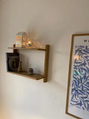 a wooden shelf on a wall with a mirror at Bredgade 10 Thyborøn in Thyborøn