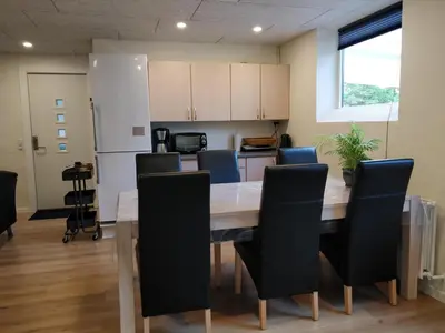 a kitchen and dining room with a table and chairs at Bændal in Bækmarksbro