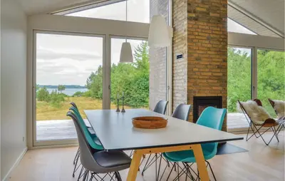 a dining room with a table and chairs at Three-Bedroom Holiday Home In Skals in Skals