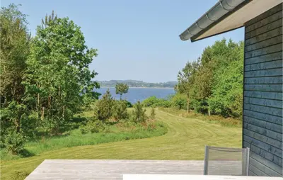 a house with a view of the water at Three-Bedroom Holiday Home In Skals in Skals