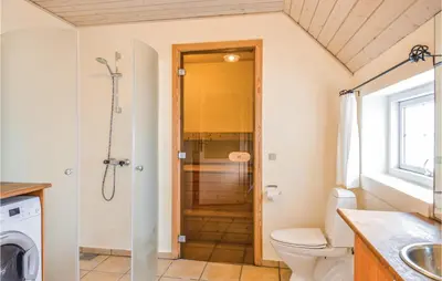 a bathroom with a shower and a toilet at Nice Home In Harboøre With Kitchen in Harboør