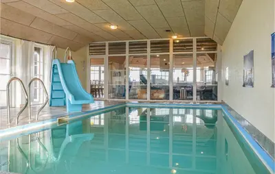 a swimming pool with a slide in a house at Nice Home In Harboøre With Kitchen in Harboør