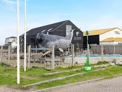 a statue of a chicken in front of a building at 4 person holiday home in Thyborøn-By Traum in Thyborøn