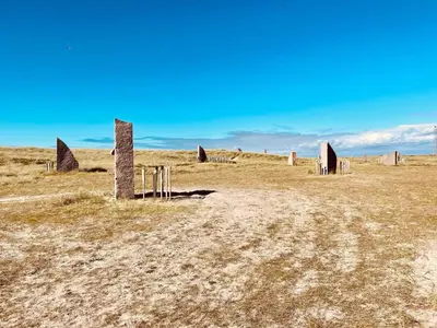 a field with some stone structures in a field at 4 person holiday home in Thyborøn-By Traum in Thyborøn