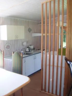 a kitchen with a counter and a table and a table and a kitchen at Summer cottage in Nøreng