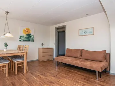 a living room with a couch and a table at 6 person holiday home in Thyborøn in Thyborøn