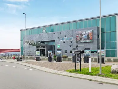 a building with people standing outside of it on a street at 6 person holiday home in Thyborøn in Thyborøn