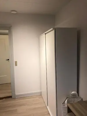 a large white refrigerator in a room at Hel lejlighed Thisted Midtby in Thisted