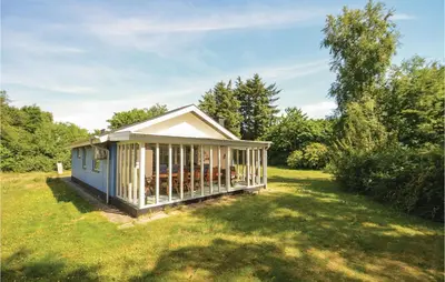 a small house in the middle of a yard at Three-Bedroom Holiday Home In Hjerm in Hjerm