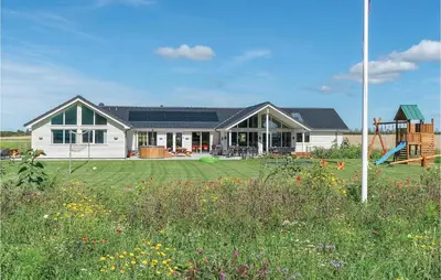 a house with a yard with a playground at 9 Bedroom Beautiful Home In Spøttrup in Spottrup