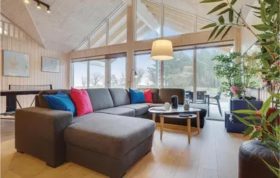 a living room with a couch and a table at 9 Bedroom Beautiful Home In Spøttrup in Spottrup