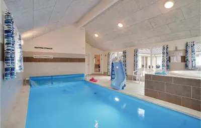 a swimming pool in a room with a tub and a sink at 9 Bedroom Beautiful Home In Spøttrup in Spottrup