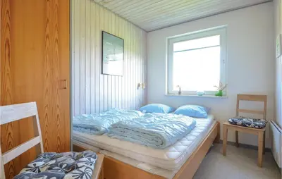 a bedroom with two beds and a window at Three-Bedroom Holiday Home In Hurup Thy in Doverodde