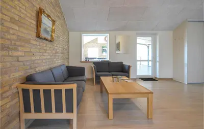 a living room with a couch and a table at Eight-Bedroom Holiday Home In Vestervig in Vestervig