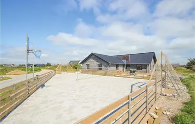 a basketball court in front of a house at Eight-Bedroom Holiday Home In Vestervig in Vestervig