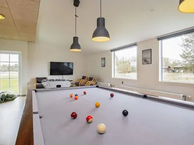 a billiard room with a pool table with balls on it at 24 person holiday home in Øster Assels in Øster Assels