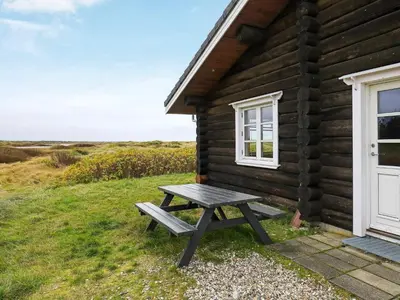 a picnic table outside of a log cabin at 10 person holiday home in Frøstrup-By Traum in Frøstrup