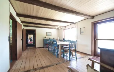 a dining room with a table and chairs at Three-Bedroom Holiday Home In Frostrup in Frøstrup