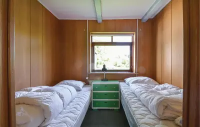 a room with two beds and a window at Three-Bedroom Holiday Home In Frostrup in Frøstrup