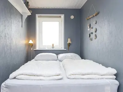 two beds in a bedroom with a window at 6 person holiday home in Harboøre-By Traum in Harboør