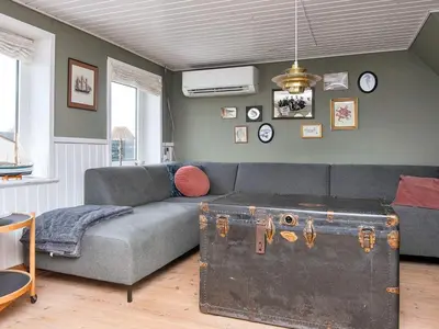 a living room with a couch and a trunk at 6 person holiday home in Harboøre-By Traum in Harboør