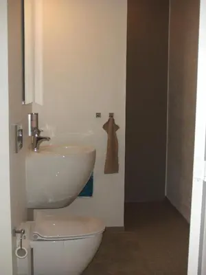 a bathroom with a white sink and a toilet at Nattely I Viborg By in Viborg
