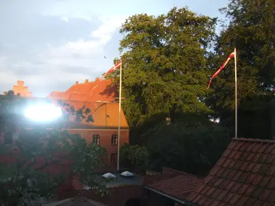 a building with two flags on top of it at Nattely I Viborg By in Viborg