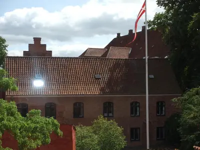 a building with a flag in front of it at Nattely I Viborg By in Viborg