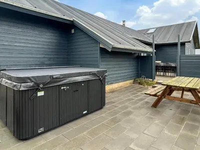a patio with a grill and a picnic table at 18 person holiday home in Harboøre in Harboør